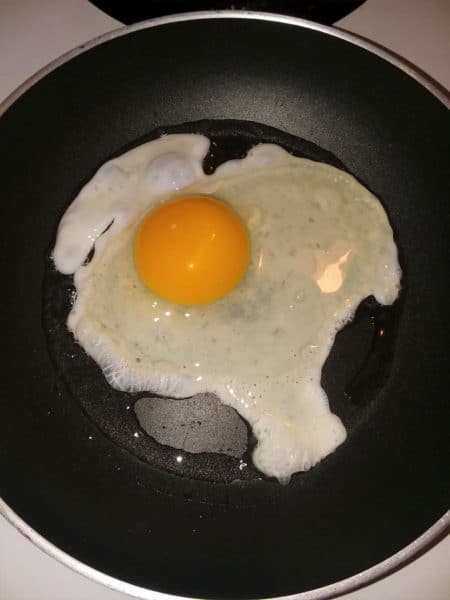 cracked egg in frying pan
