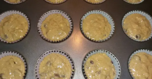 banana muffin batter in muffin pan