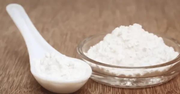 xanthan gum powder in a bowl and spoon