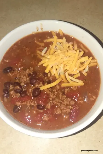 chili in a bowl topped with cheese