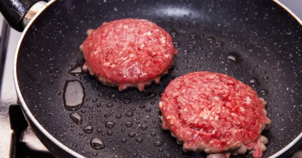 hamburgers in a frying pan