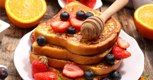 french toast on a plate with fruit