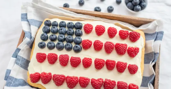 cake that looks like a flag with raspberries and blueberries